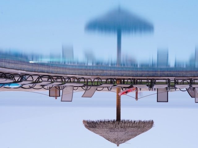 upside down reflection of an empty pool deck