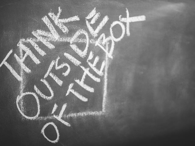 think outside the box written on chalkboard