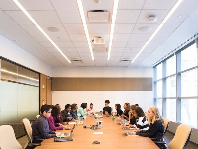 group of people holding a meeting in a conference room