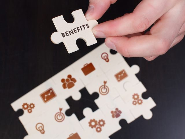 Businessman finishing ECM puzzle, the last piece says benefits