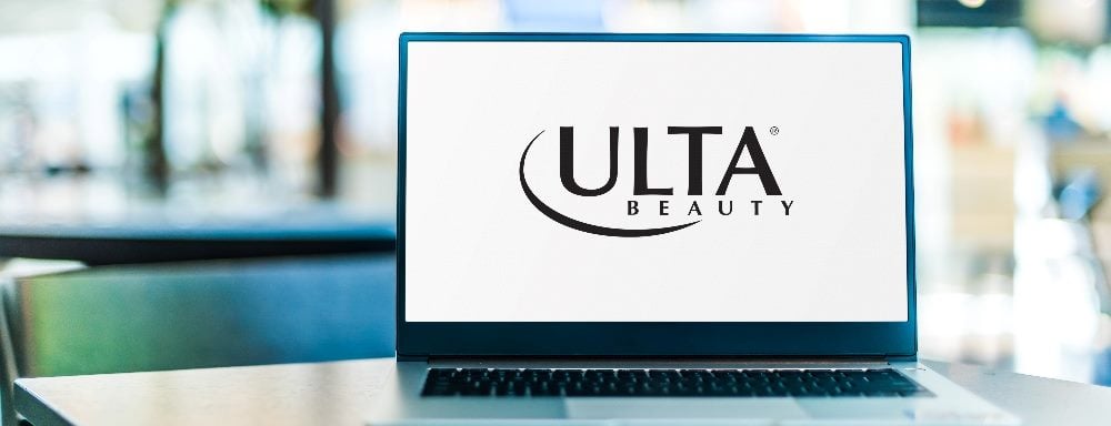 A laptop sits open on a table displaying Ulta Beauty home page and logo, suggesting the importance of AI in customer experience case stories.