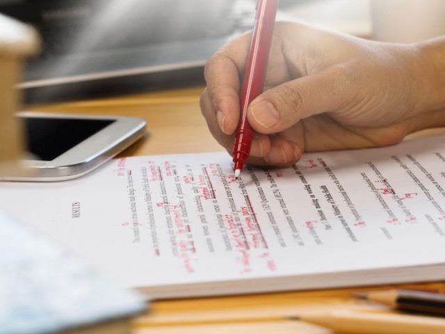 red pen editing a paper article
