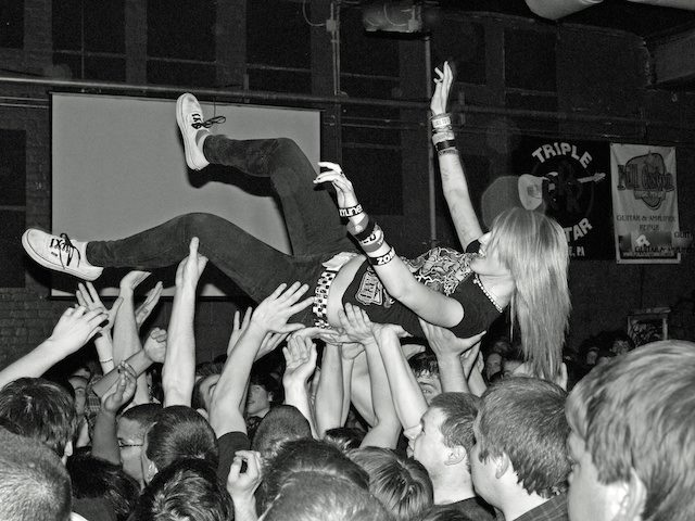 crowd surfing in a mosh pit