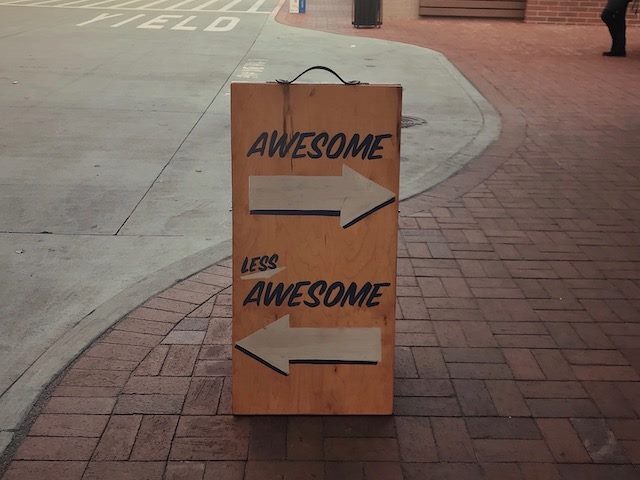 awesome, less awesome sign pointing in two different diirections