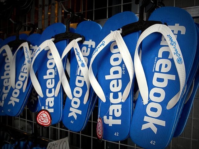 a row of three facebook-themed flip-flops