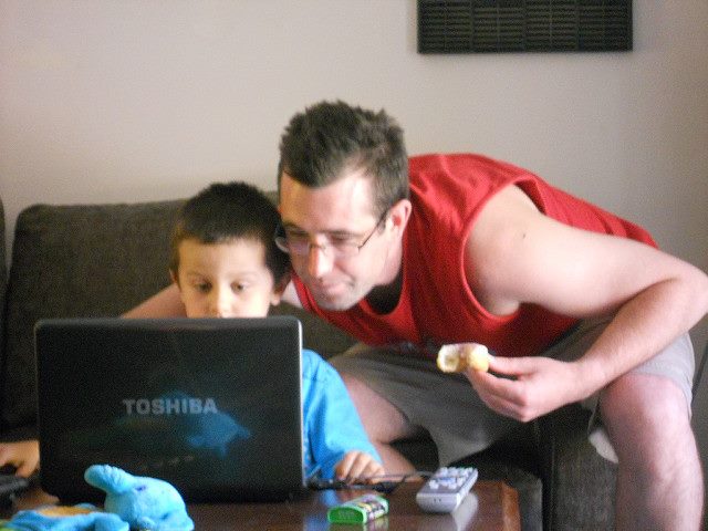 boy and father looking at online instructions 