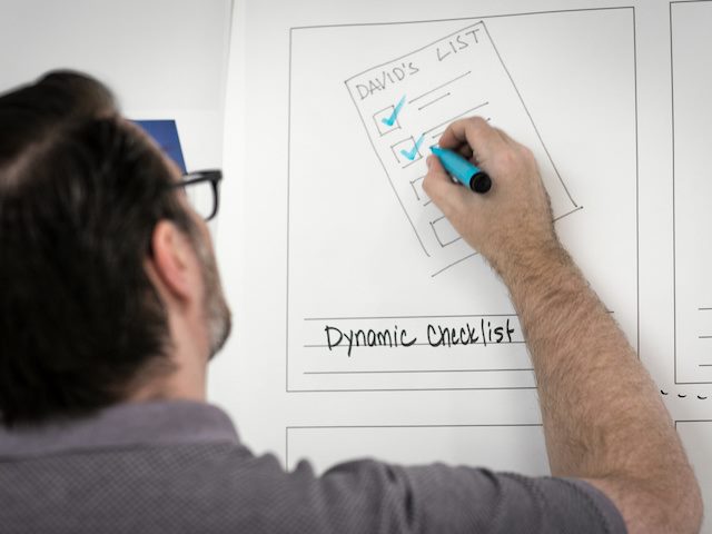 man writing on a whiteboard