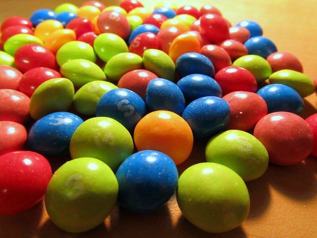 Different-colored Skittles on a table.