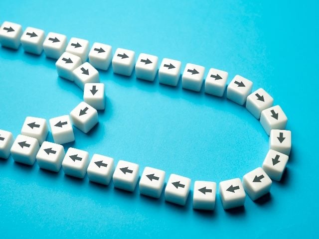 White cubes with black arrows are configured in a way to represent shorter and longer paths in piece about customer experience trends and shorter customer journeys. 