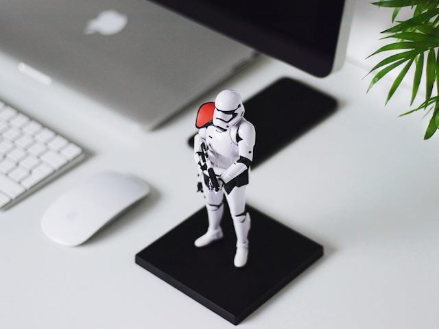 storm trooper action figure placed next to a computer