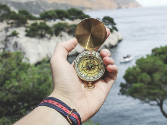 A person holding a compass
