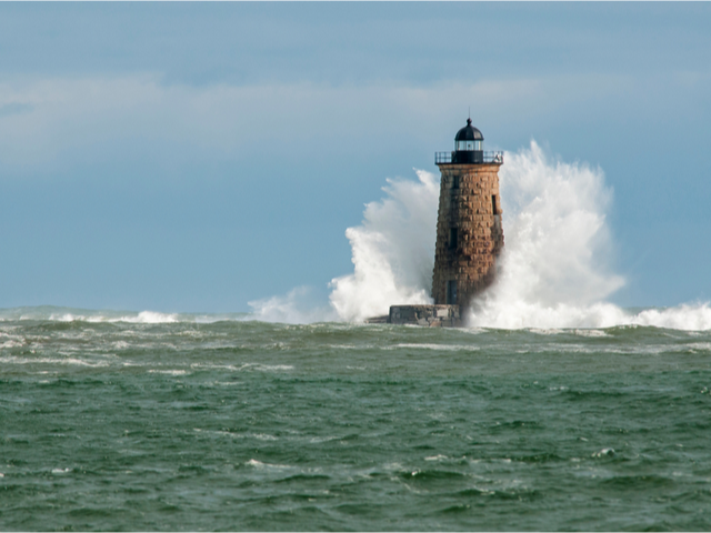 Giant waves cover the stone tower of Whaleback lighthouse in southern Maine