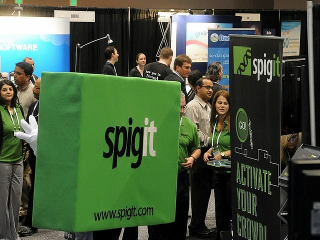 people at spigit exhibition booth at tech conference