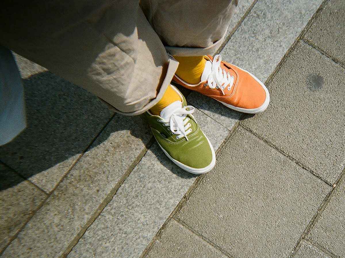 Mismatched sneakers, colored green and orange.
