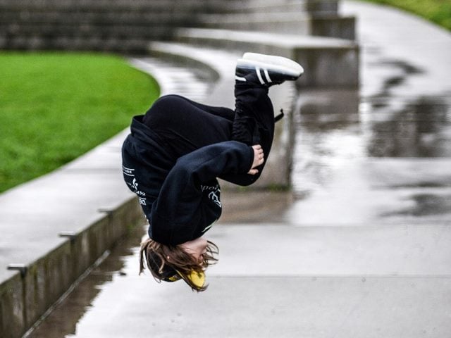A young boy in mid-air during a flip.