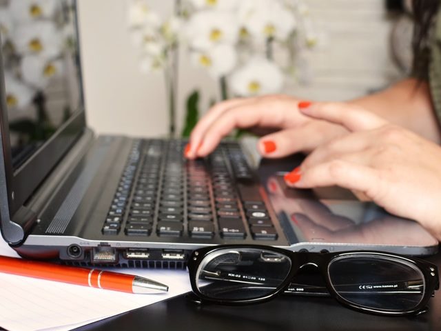 woman typing on a PC