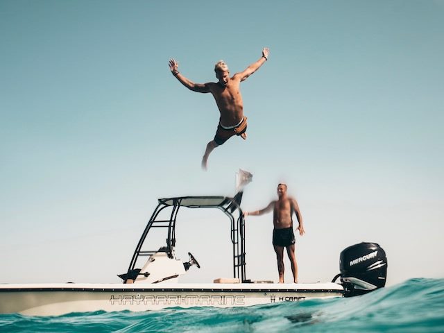 launching off a dock to bellyflop into the water