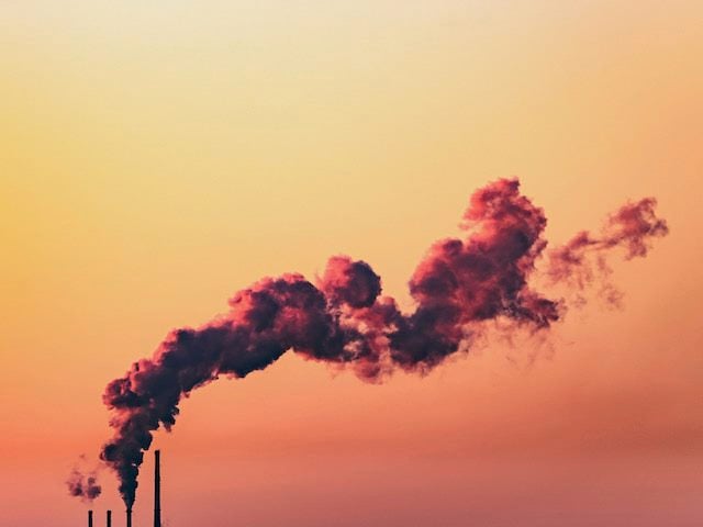 emissions from a factory blowing up into the sky