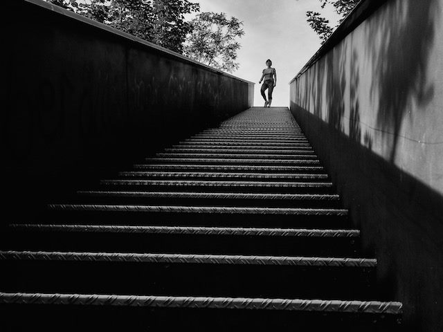woman standing at the top of a staircase