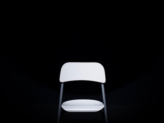 empty folding chair in empty space, high contrast black and white