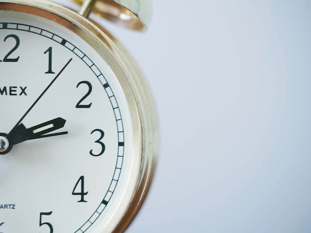 close up of a clock face with second hand visible