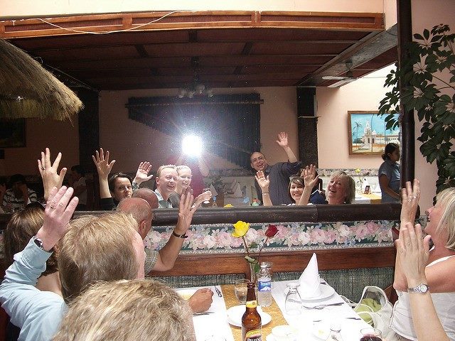 People at a dinner looking into a mirror. Organizations must look into the mirror and get their internal ship straight in order to deliver strong digital customer experiences.
