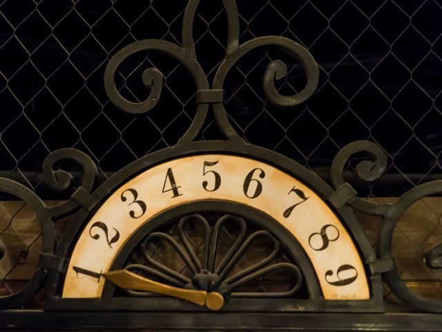 An ancient placard with figures and an iron pointer used in the elevator