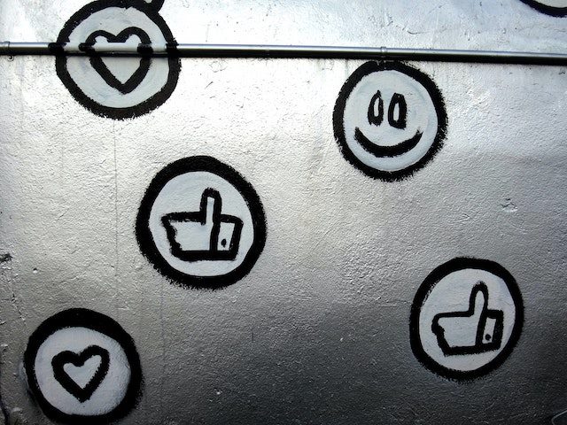 painted icons indicating social media engagement on a silver background
