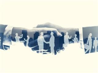 workplace silhouettes in shaking hands