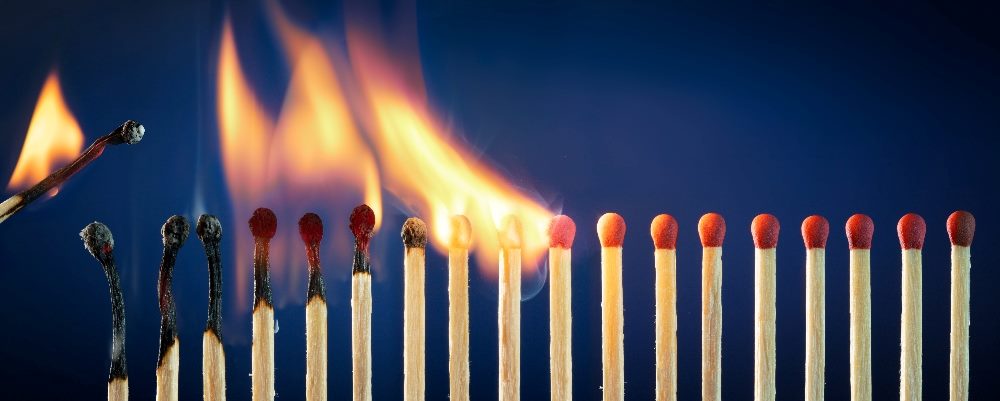 Matches lit In row burning in a chain reaction in piece about viral marketing campaigns and brand loyalty.