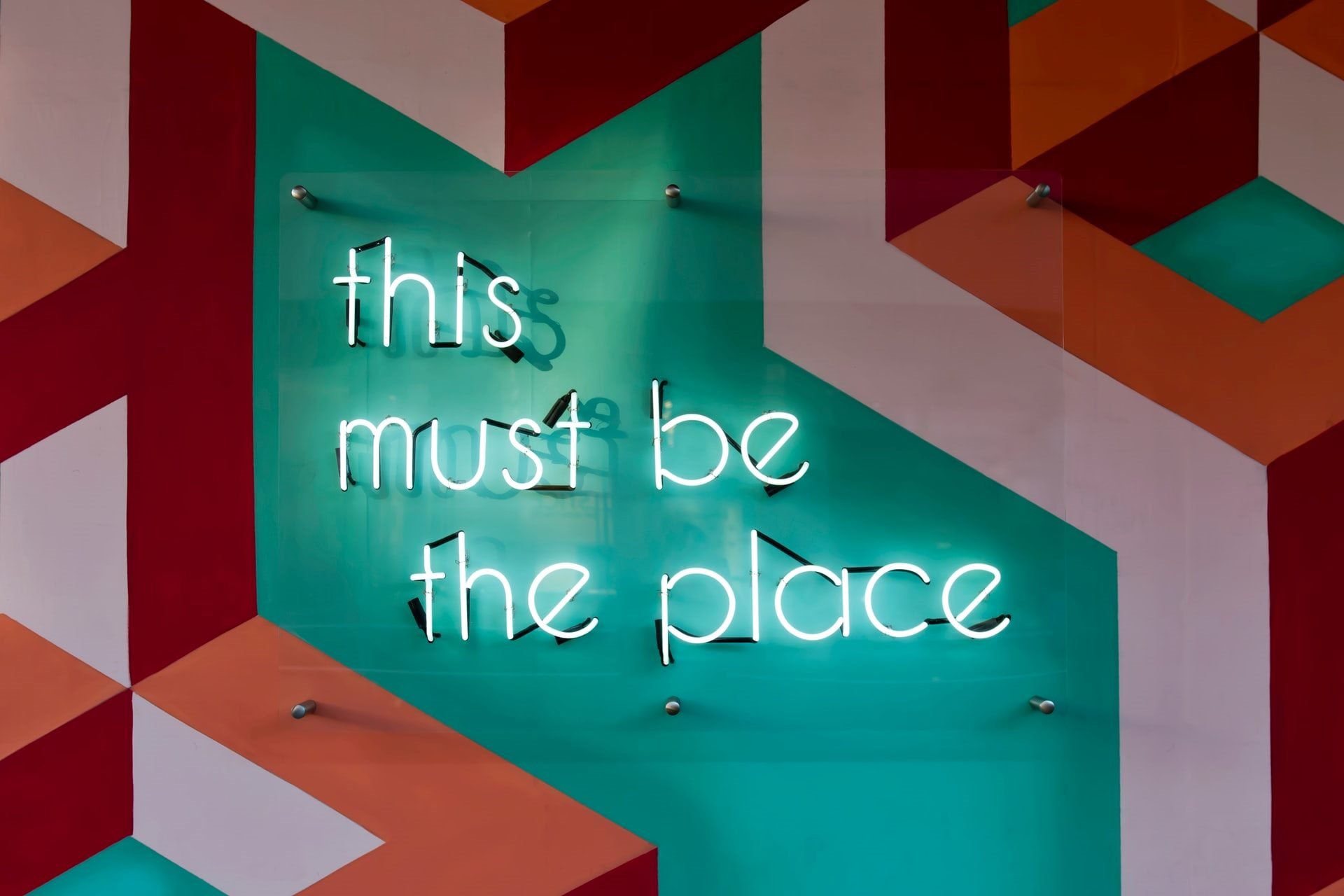 this must be the place message in neon on wall