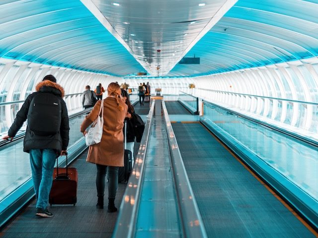 airport scene, travellers on walkway