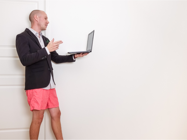A man on a video conference job interview with a suit jacket but no pants -  Video Interview Concept