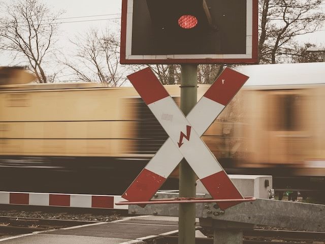 train tracks crossing warning - barrier, light, hazard sign