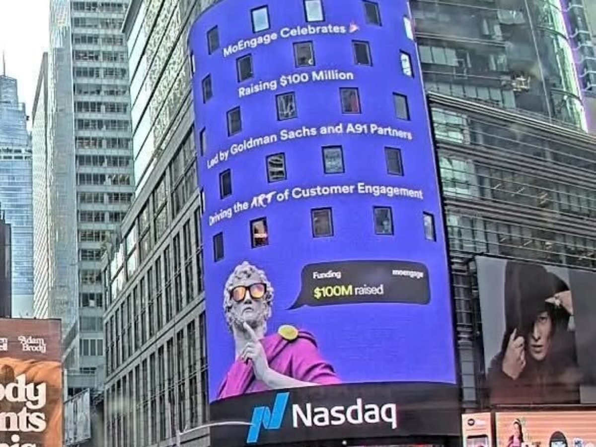 Digital billboard in New York’s Times Square displaying MoEngage’s announcement of $100 million in funding led by Goldman Sachs and A91 Partners, featuring the Nasdaq logo and a stylized statue graphic celebrating the milestone.