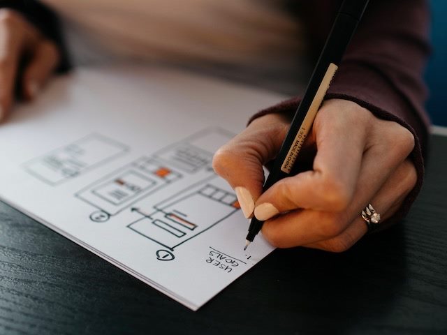 close up of a woman's hands creating  a wireframe design