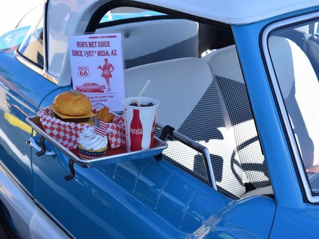 drive through food resting on the side of a blue car