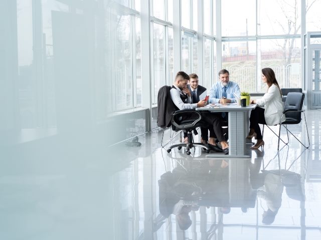 A meeting of business professionals sitting at a table.