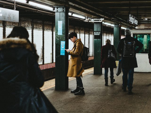 man on cellphone in subway station