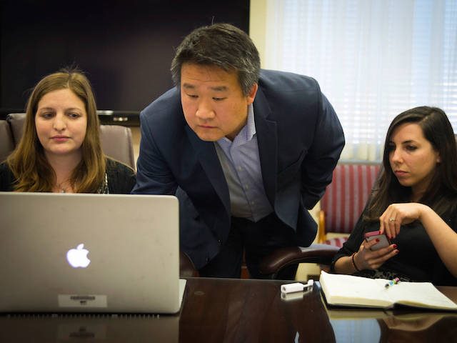 team looking at a laptop screen together