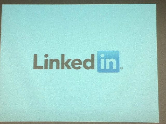 The LinkedIn logo on a screen projector during a presentation. LinkedIn debuted this week updates to its Sales Navigator platform.