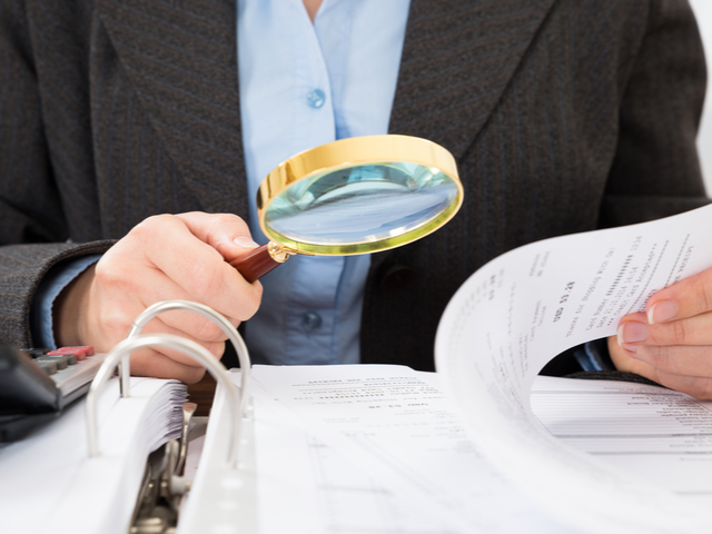 A man looking at the fine print in a contract - CDP Concept