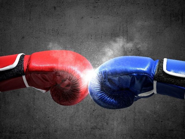 Two hands with one wearing a blue boxing glove on the right and another wearing a red boxing glove on the left clash in piece about contextual targeting versus cookies. 