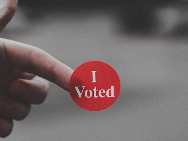 I voted sticker on someone's finger