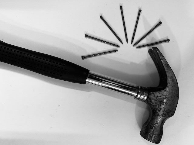 a hammer and six nails