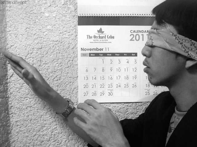 blindfolded man reaching out with false hand