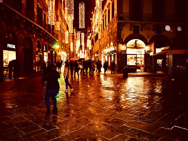 Rainy streets reflecting in nighttime light. 