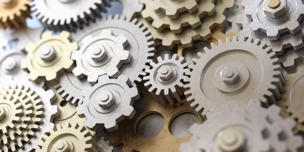 Metallic gears and cogs interlocking together seamlessly in piece about data integration strategies.