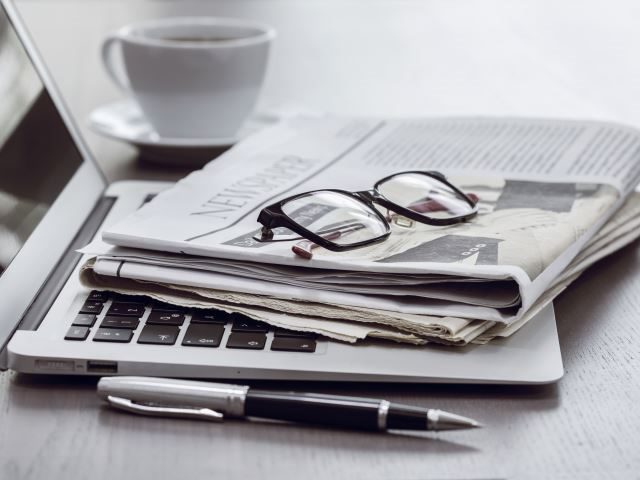 A folded newspaper on a laptop - Workplace Newsbyte