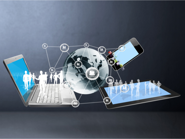 An abstract image with a globe, a laptop and a tablet, all of them interconnected - global technology concept 